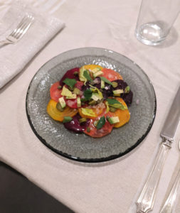 Beet salad with place setting on a white table cloth