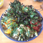 Large platter of grilled vegetables with parsley dressing